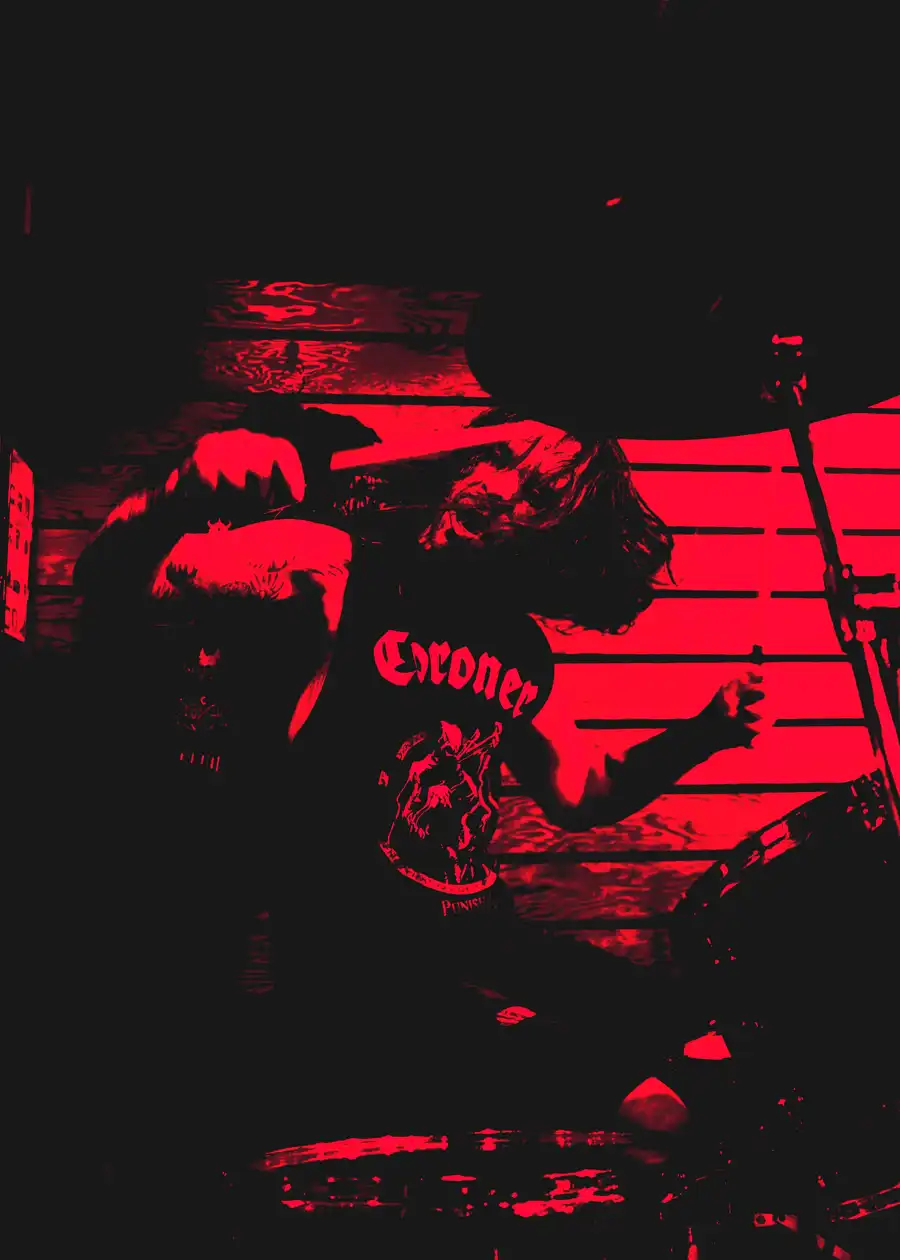 Thom performing live for Worship Pain under heavy red light